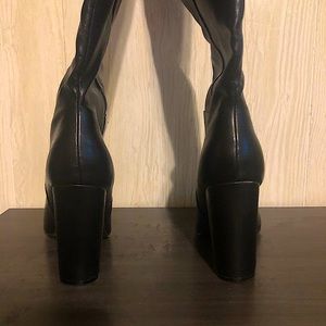 Black faux leather thigh high formal boots. Slightly worn around edges.